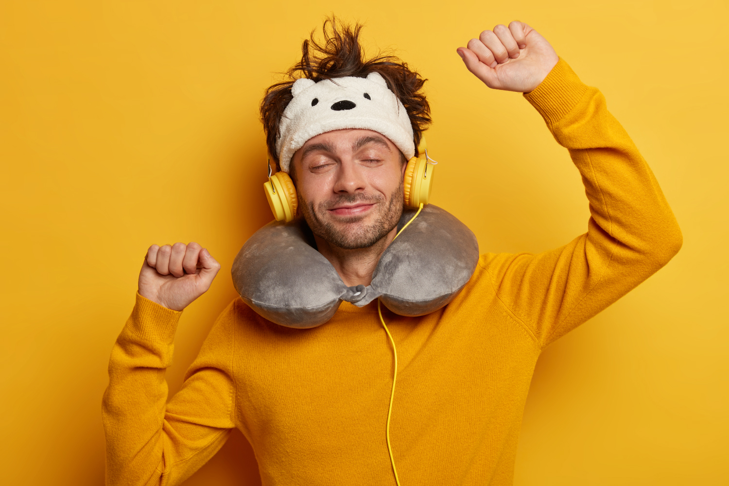 ilustrasi seorang laki-laki sedang menggunakan pillow neck dan masker mata. Serta sedang mendengarkan musik melalui headphone.
